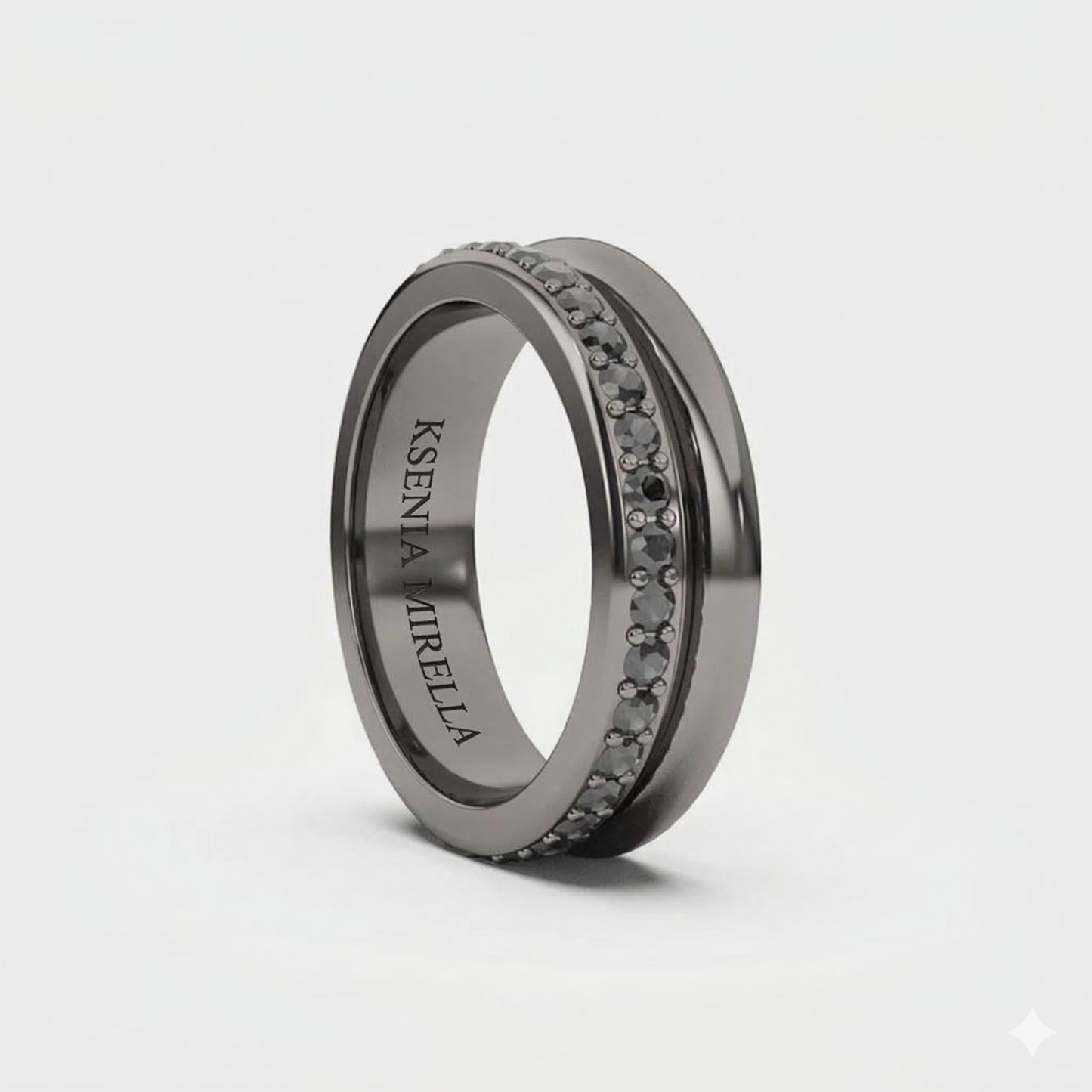 A black gold band ring with black diamonds set around its circumference. Ksenia Mirella London Fine Jewellery