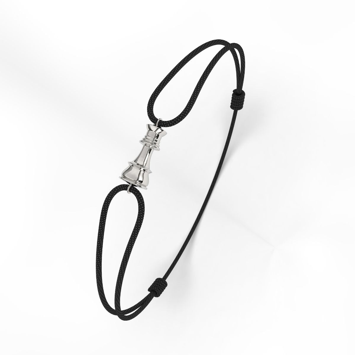 A silver bracelet with a geometric patterned clasp, attached to a black cord.