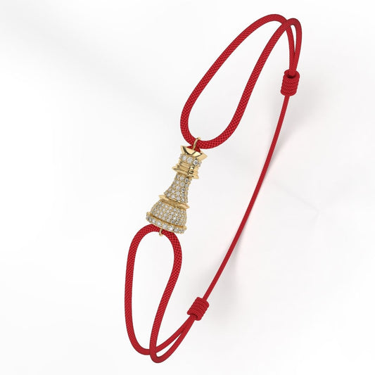 A Yellow Gold bracelet with white diamond pavé accents, featuring a red cord-style fastening.