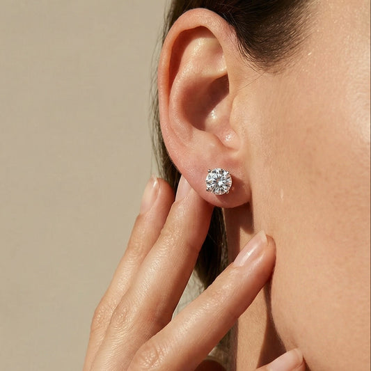 Close-up of a person wearing a diamond earring with a neutral background Ksenia Mirella Jewellery Fine Jewellery