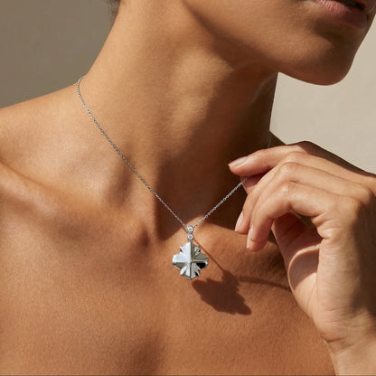 White gold white diamond clover style chain necklace worn by a model 