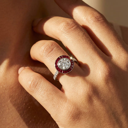 Art Deco Ruby platinum engagement ring Close-up of a hand wearing a ring with a red gemstone on a neutral background