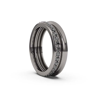 A black gold band ring with black diamonds set around its circumference.