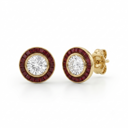 A pair of gold round stud earrings featuring a central clear round-cut gemstone surrounded by a halo of small deep red stones, shown on a white background.