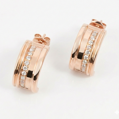 Rose gold hoop earrings with diamond accents on a light gray background