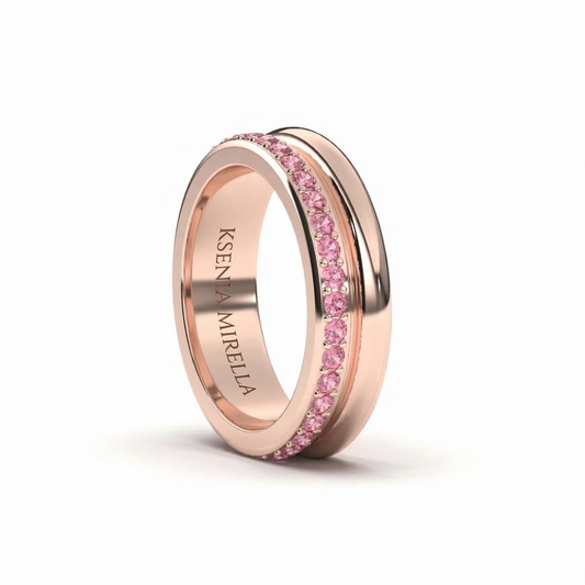 Rose gold ring with pink sapphires on a white background