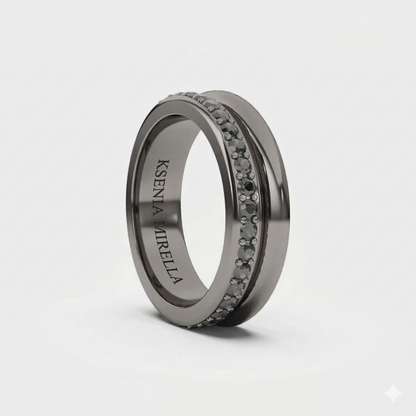 A black gold band ring with black diamonds set around its circumference.