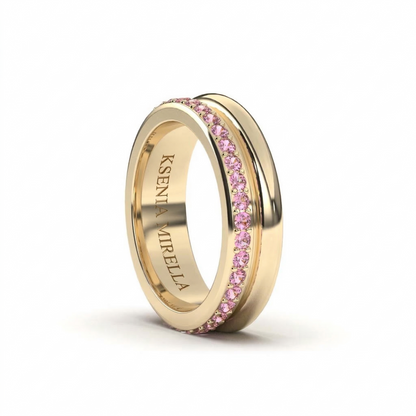 Yellow Gold ring with pink Sapphires on a white background