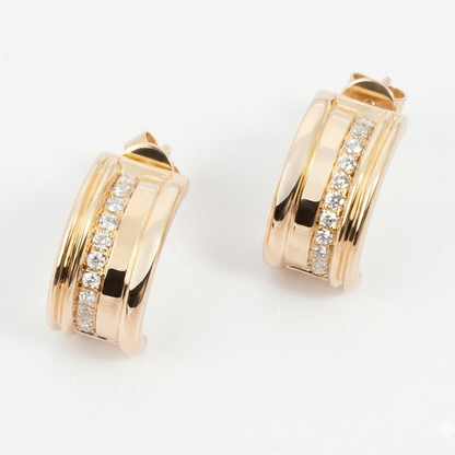 Gold hoop earrings with diamond accents on a white background