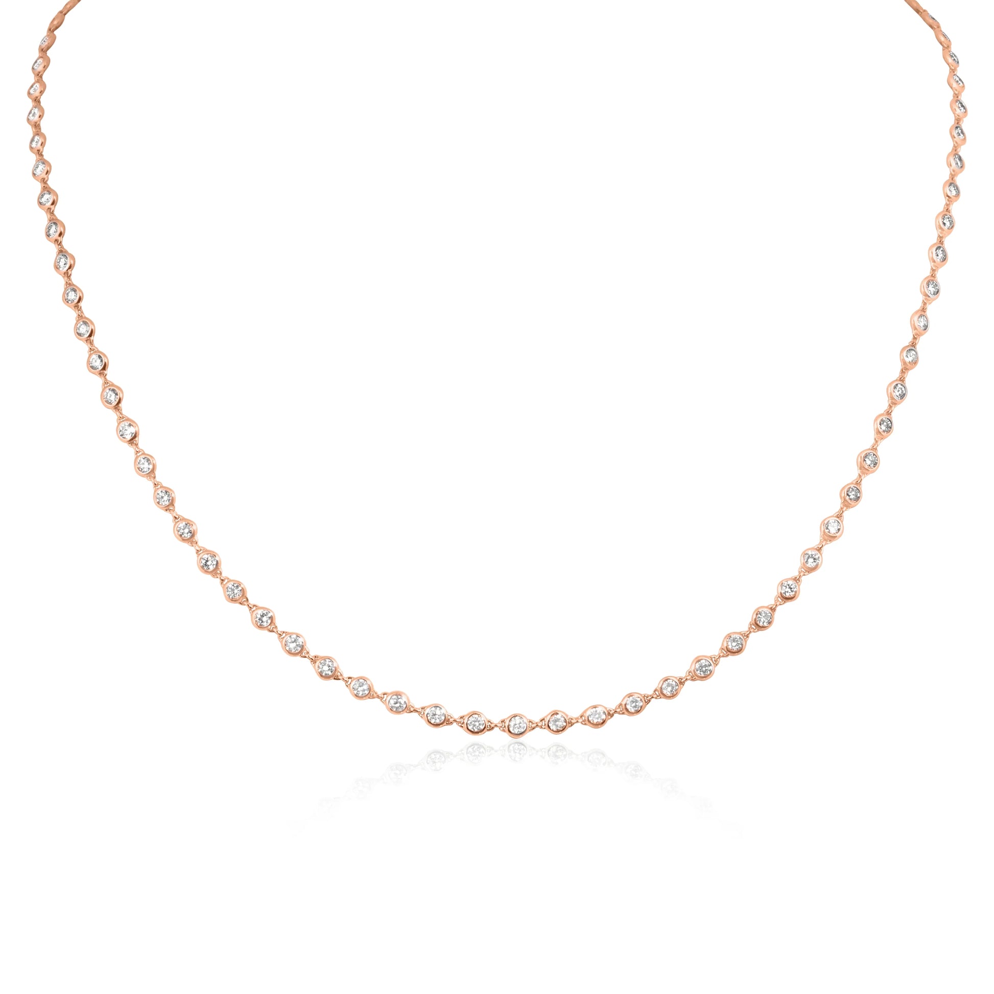 A delicate rose gold tennis necklace featuring marquise-cut clear stones set along the chain, displayed on a clean white background with a soft reflection below.