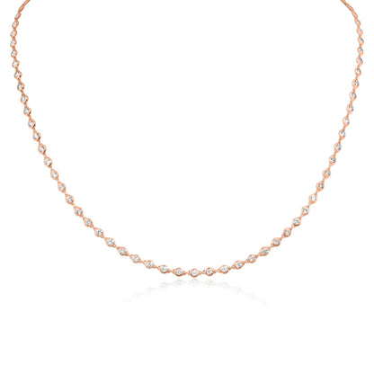 A delicate rose gold tennis necklace featuring marquise-cut clear stones set along the chain, displayed on a clean white background with a soft reflection below.