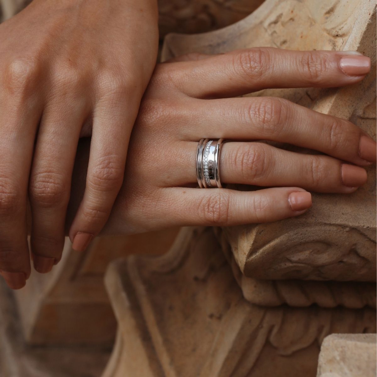 White gold diamond band ring by Ksenia Mirella Jewellery worn on hand in warm natural light