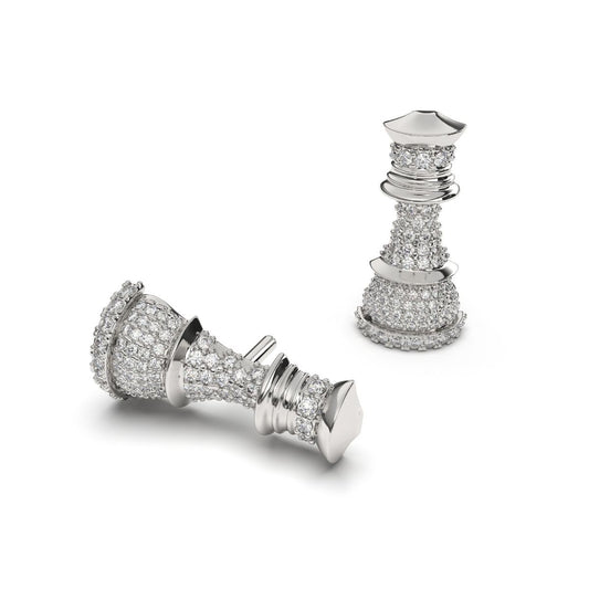 A pair of silver pave diamond stud earrings designed to resemble a chess piece, set against a white background.