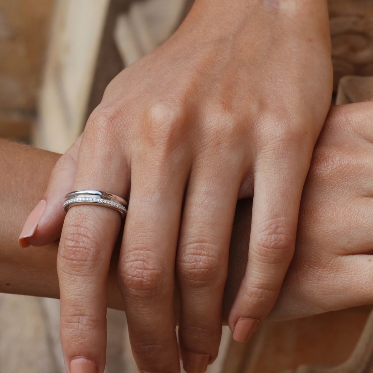 White gold diamond band ring by Ksenia Mirella Jewellery worn in close-up hand detail