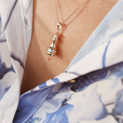 Silver chess queen pendant necklace by Ksenia Mirella Jewellery worn with floral blouse styling
