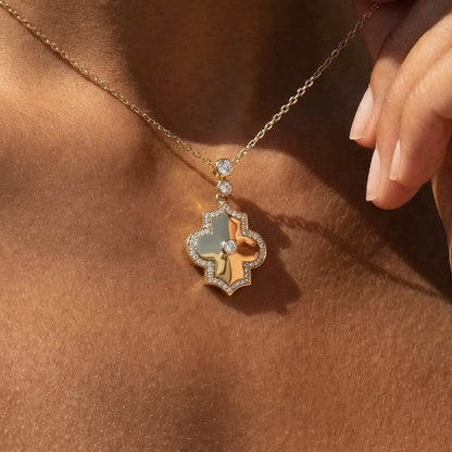 Close-up of a necklace with a pendant on a person's neck in yellow gold and white diamond 