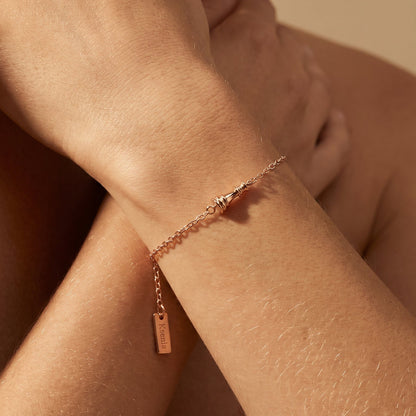 Ksenia Mirella Jewellery Icon Queen Chain Bracelet Rose gold bracelet on a person's wrist with a soft beige background