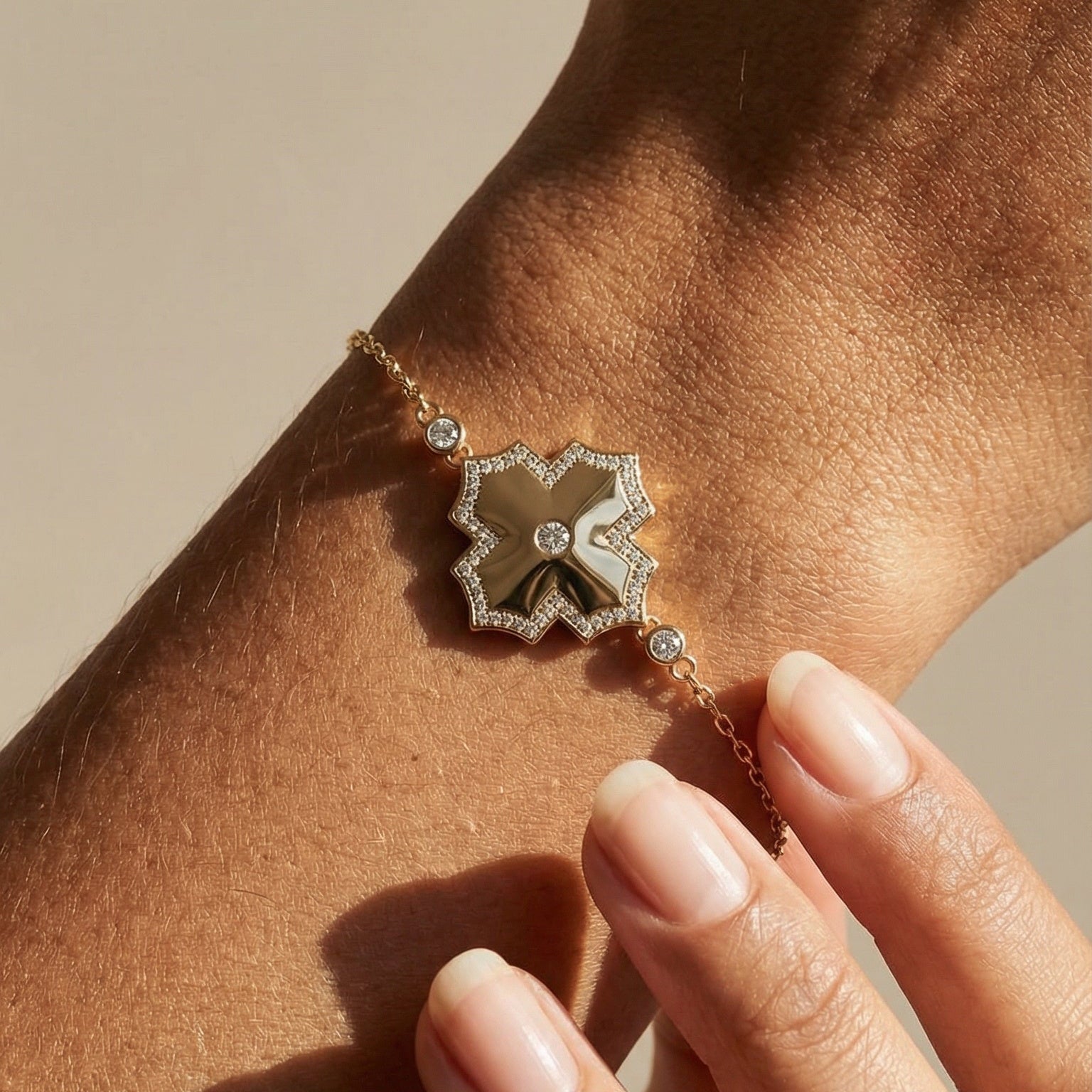 Close-up of a person's wrist wearing a decorative bracelet with a star-shaped clasp.
