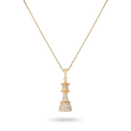 A yellow gold chess with white diamonds necklace with a pendant featuring the queen piece on a chain.
