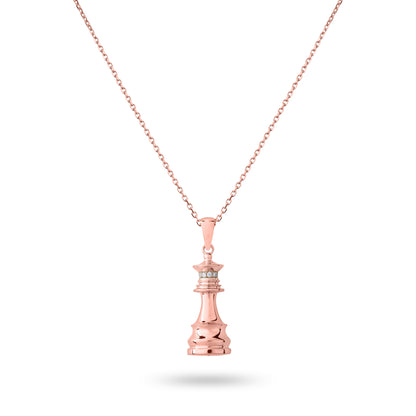 A rose gold chess necklace with a pendant featuring the queen piece on a chain.